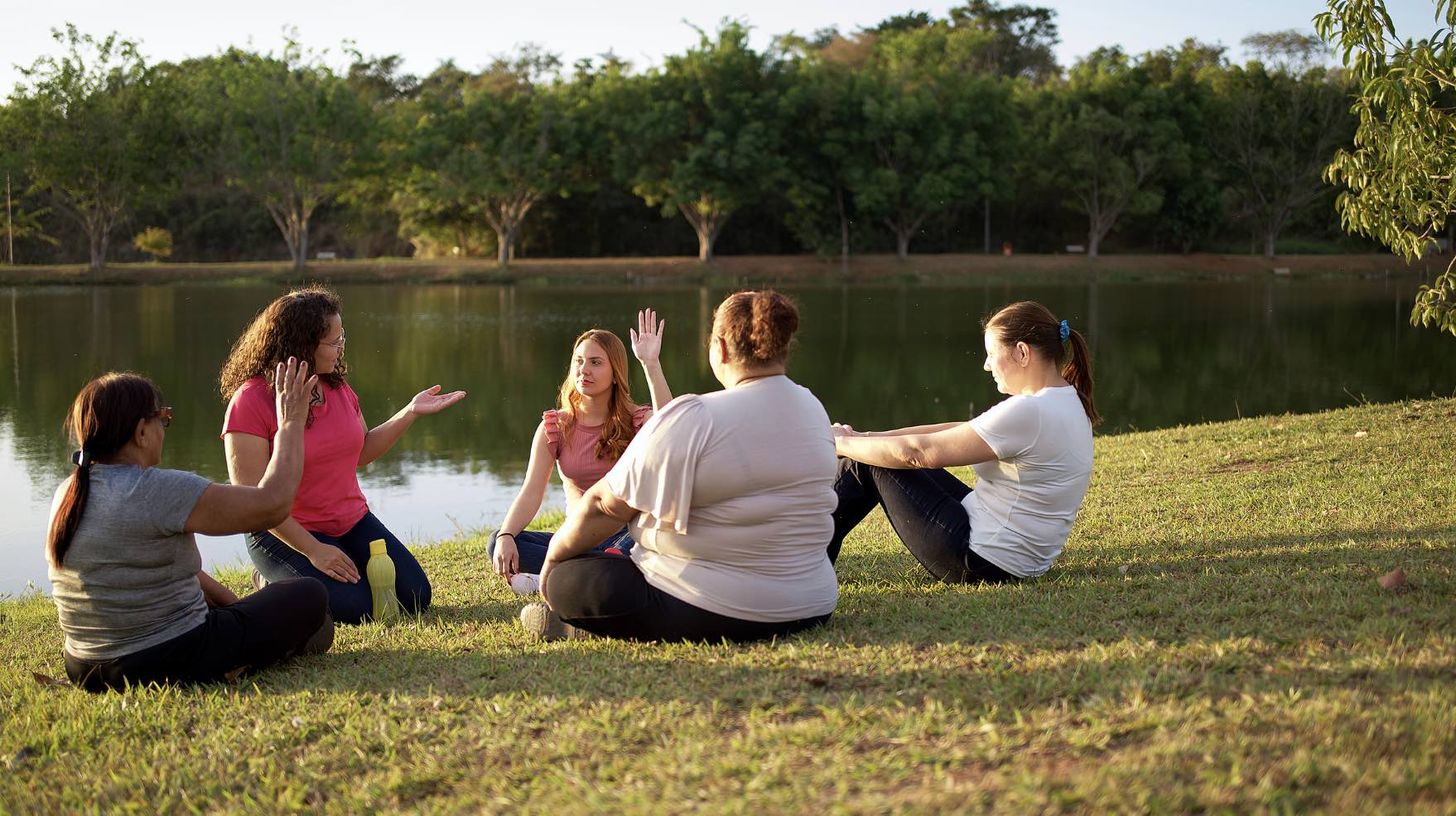 Women having a Group therapy Session next to a lake.